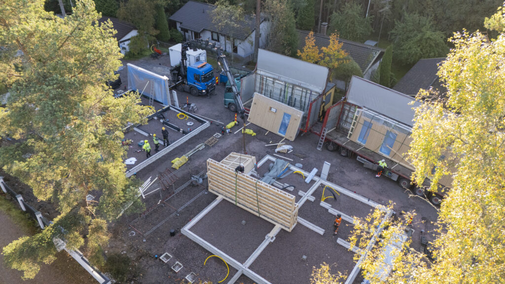 Peltrans Oy:n nosturiauto nostamassa omakotitalon seinäelementtejä Espoon työmaalla.